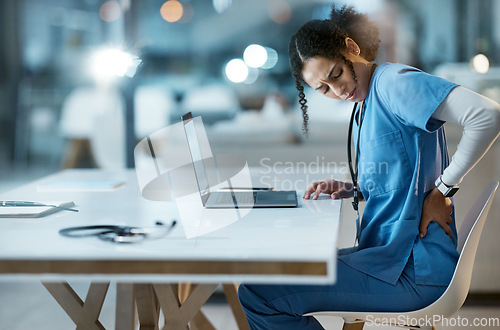 Image of Back pain, stress and doctor in her office at the hospital working on a diagnosis or cure. Computer, healthcare and female medical worker with a muscle sprain, ache or inflammation at medicare clinic