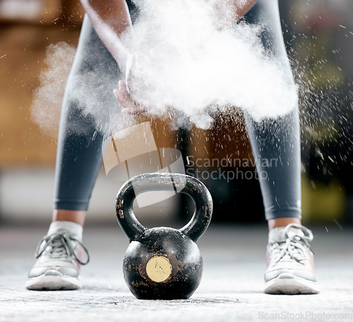 Image of Fitness, chalk or legs by a kettlebell for training, workout or exercise with dust or powder for hand grip. Body builder, mindset or healthy athlete with a heavy weight, motivation or focus at gym
