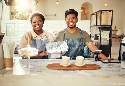 Image of Portrait, collaboration and hiring sign by small business owners happy at coffee shop or cafe in support together. Team, recruitment and friends due to startup growth due to vacancy, join us or job