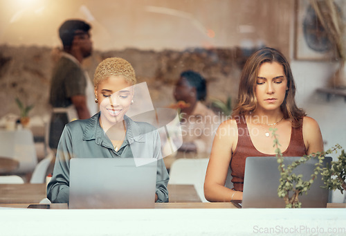 Image of Working, laptop and business women in cafe window for remote work, freelance career and networking. Communication, technology and female workers with computer for project, report and typing email