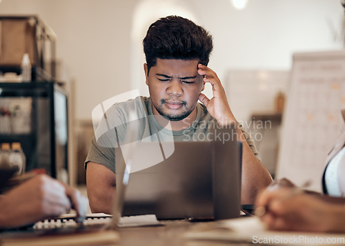 Image of Businessman, thinking and stress on laptop in modern office, startup or creative company with ideas, vision or strategy planning. Confused, doubt and question for worker on technology in team meeting