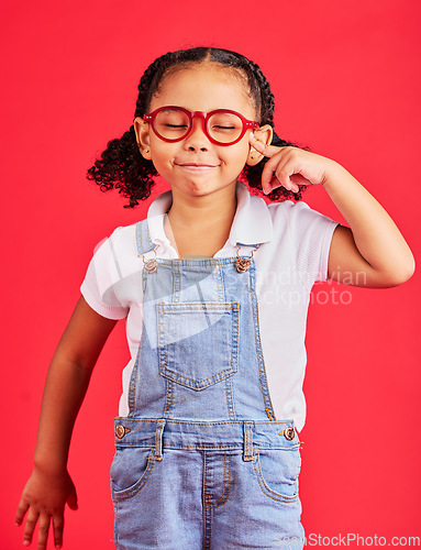 Image of Vision, glasses and portrait of child thinking with eyes closed and isolated on red background. Ideas, eyesight and happy playful expression, goofy little girl in spectacles for eyesight in studio.