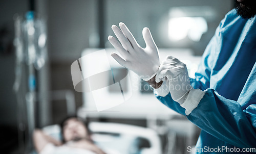 Image of Hands, gloves and surgeon preparing for surgery in a consultation room in the hospital. Healthcare, surgical and medical doctor ready for a operation in the ER or emergency theatre in medicare clinic