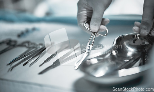 Image of Healthcare, surgeon and medical instruments for surgery in a ER or operating room in the hospital. Emergency, steel appliances and nurse giving tools to a doctor for a operation in surgical theatre.