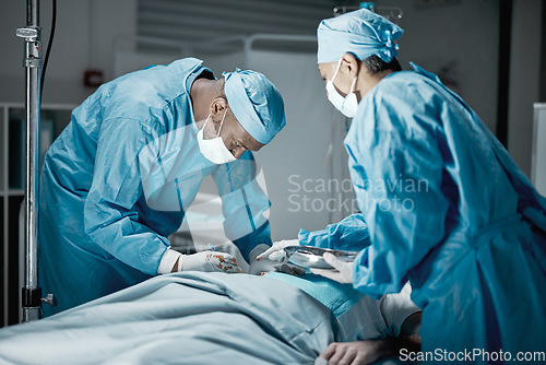 Image of Hospital, surgery and healthcare doctors in operating room for emergency operation on patient. Health, collaboration and team of medical surgeons working with surgical tools to save a life in clinic.