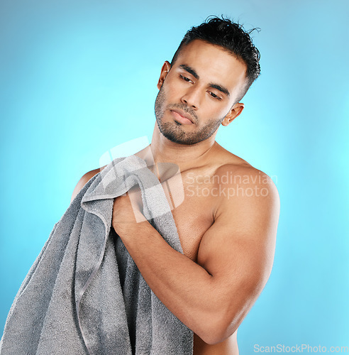 Image of Shower, towel and man isolated on blue background for skincare, beauty and body wellness with mockup space. Washing, hygiene and cleaning model or young person in studio for dermatology or self care