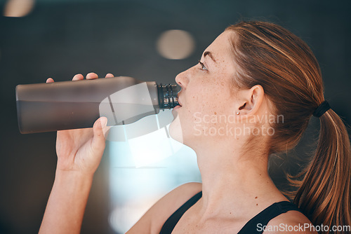 Image of Fitness, break and woman athlete drinking water for thirst, hydration and health in a training studio. Sports, wellness and young female enjoying a healthy cold beverage after a workout or exercise.