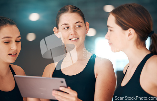 Image of Sports, tablet and team talking, workout plan and research for routine, training and exercise in gym. Women, female athletes or healthy girls with device, conversation or online schedule for practice