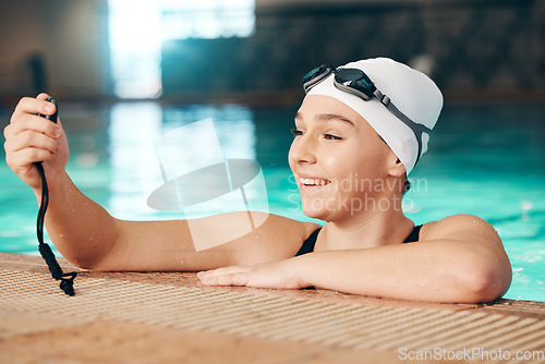 Image of Time, swimming and girl with a watch for training, fitness and motivation in a pool. Check, sports and happy athlete reading a timer for workout, cardio and competition in the water for a race