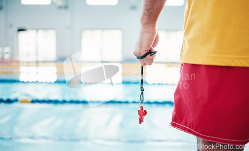 Image of Hands, lifeguard and whistle by swimming pool for water safety, security or ready for rescue indoors. Hand of expert swimmer holding signal tool for warning, safe swim or responsibility for awareness