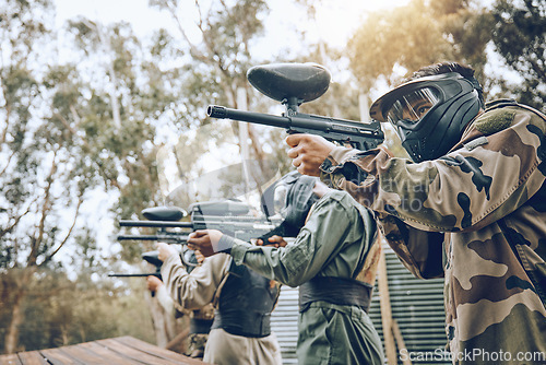 Image of Team, paintball and shooting range for target practice in preparation for extreme sports match or game outdoors. Group of people, soldiers or army aiming to shoot by training bunker for competition