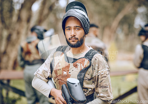 Image of Paintball, sports and portrait of man with gun in woods ready for game, arena match and shooting battle. Training, adventure and male with weapon in camouflage, military clothes and action gear