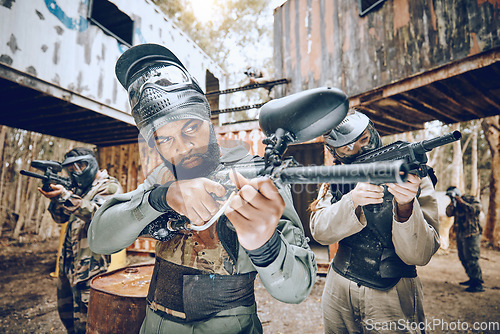 Image of Paintball player, gun and soldier group together for military, army and field game teamwork training. Exercise, fitness and target shooting of man with battlefield players in sports event with focus