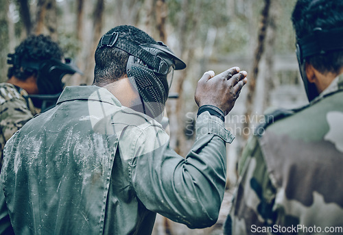 Image of Training, paintball and man with hand sign for planning, strategy and plan of action outdoor. Military, men and hands by guy leading team in sports, shooting and intense target practice together