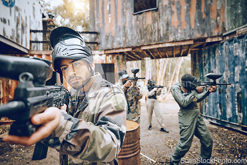 Image of Paintball, teamwork and soldier group together for military, army and field game training. Exercise, fitness and target shooting of a man with battlefield players in a sports event outdoor with focus