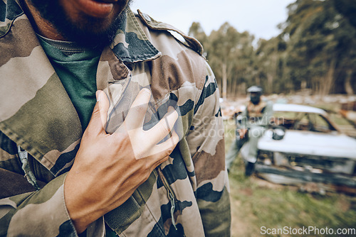 Image of Paintball, camouflage and man at a match, competition or extreme sports training on a battlefield. Fitness, hand and male athlete or soldier with a military outfit for a fun outdoor game or practice.