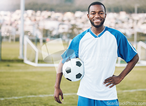 Image of Sports, soccer and portrait of black man with ball and smile on face with motivation for winning game in Africa. Confident, proud and happy professional football player at exercise or training match.