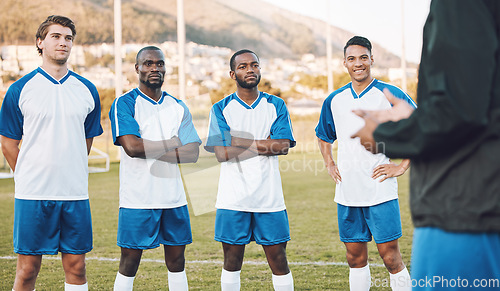 Image of Team, football player and coaching on field for sports training, games strategy and competition planning together. Focus, leadership and man talking to soccer people or men on pitch for workout goals