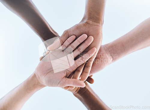 Image of Sports, teamwork and stack of hands for support, motivation and community with blue sky. Collaboration, team building and group of people ready for success in game, fitness and training outdoors