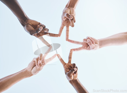 Image of Below, hands and star, sports and collaboration, partnership and huddle against sky background. Low angle, peace and friends hand sign support of teamwork, goal and mission, diversity and training