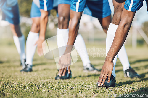 Image of Man, soccer players and stretching legs before sports game, match or start on outdoor field. Group of men in team warm up stretch preparation for fitness training or football practice on green grass