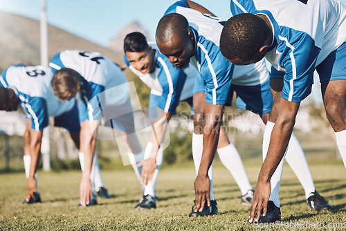 Image of Soccer, sports and warm up with a team outdoor on a field getting ready together for a competitive game. Football, fitness and stretching with a male sport group of friends on a pitch before a match