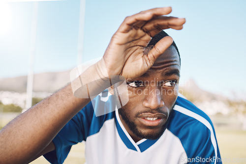 Image of Tired black man, face and soccer player on outdoor field, playing game or football training with energy and exhausted athlete. Team sport, sweating and fitness, challenge and fatigue with workout