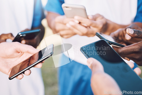 Image of Connection, social media and hands with phone for communication, bluetooth and soccer chat. Networking, sync and football players reading information or strategy on a mobile in a circle for sports
