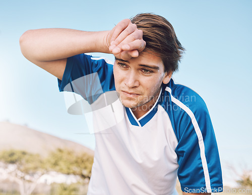 Image of Man, tired with face and soccer player on outdoor field, playing game or football training with energy and exhausted athlete. Team sport, sweating and fitness, challenge and fatigue with workout