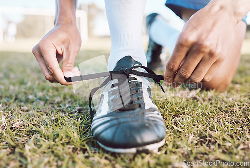 Image of Sports, soccer field and man tie shoes for game, ready for training, workout and fitness outdoor. Male, guy or athlete tying shoe lace, before practice or exercise for wellness, cardio or competition