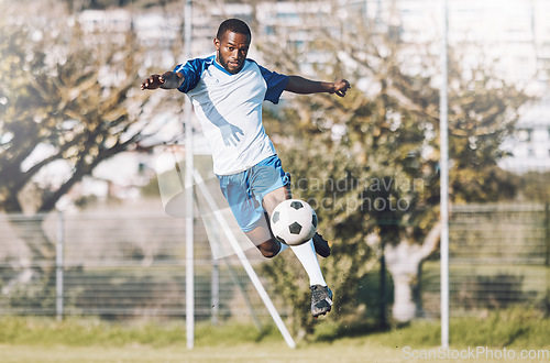 Image of Sports, soccer and man in action with ball playing game, training and exercise on outdoor field. Fitness, workout and male football player kicking, running and score goals, winning and competition