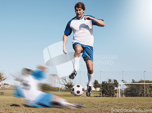 Image of Soccer, tackle and motion blur with a sports man running on a field during a competitive game or training. Football, fitness or health and a male athlete or player on a pitch with an opponent