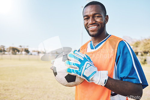 Image of Soccer, goal keeper and portrait of black man with ball and smile on face, motivation for winning game in Africa. Confident, proud and happy professional football player at exercise or training match