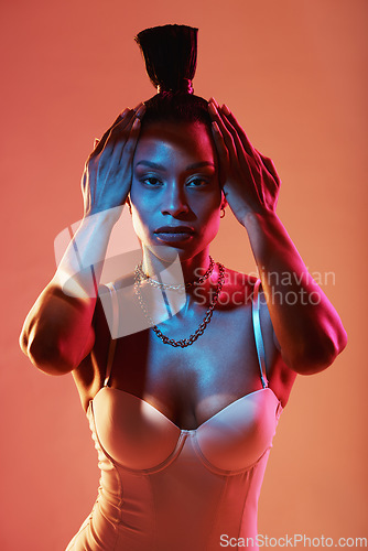 Image of Portrait, hands and hair with a model black woman in studio on a neon background for beauty. Fashion, art and kaleidoscope with an attractive young female posing indoor for culture or cosmetics