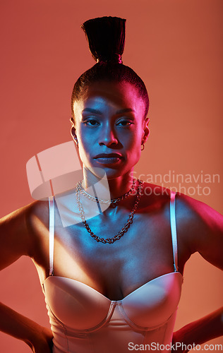 Image of Portrait, neon and style with a model black woman in studio on a kaleidoscope background for beauty. Art, makeup and fashion with an attractive young female posing indoor for culture or cosmetics