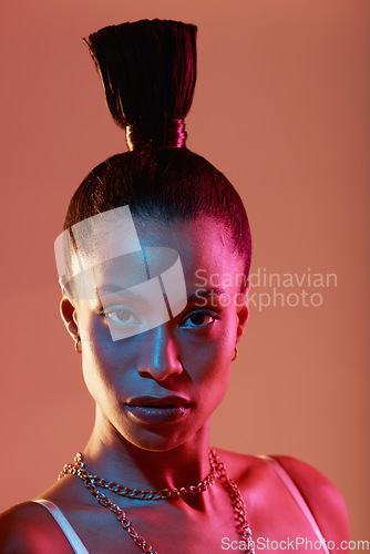 Image of Portrait, makeup and neon with a model black woman in studio on a kaleidoscope background for beauty. Art, fashion and style with an attractive young female posing indoor for culture or cosmetics