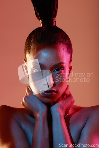 Image of Portrait, art and neon with a model black woman in studio on a kaleidoscope background for beauty. Face, makeup and style with an attractive young female posing indoor for culture or cosmetics