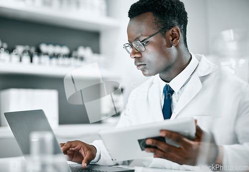 Image of Science, research and black man with tablet and laptop for medical report, analytics and test results. Biotechnology, healthcare and scientist with digital tech for data, lab study and innovation