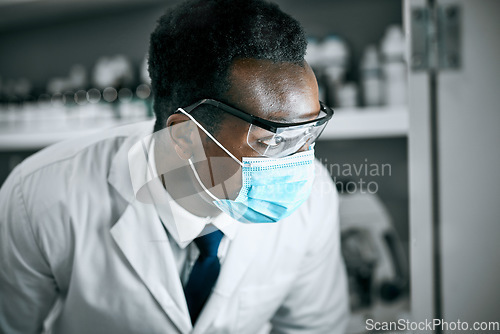 Image of Covid, mask and scientist working in a lab for research on a pandemic for healthcare and medicine. Black man, technician and science professional or doctor learning cancer or epidemic development
