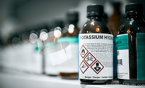 Image of Science, pharmaceutical chemical and bottle on shelf in laboratory for medical research. Healthcare, medicine and innovation in manufacturing of poison antidote with danger on warning label in lab.