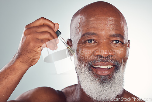 Image of Cosmetics, black man and serum for skincare, dermatology and guy on grey studio background. African American male or senior gentleman with collagen, oil and treatment for natural beauty or anti aging