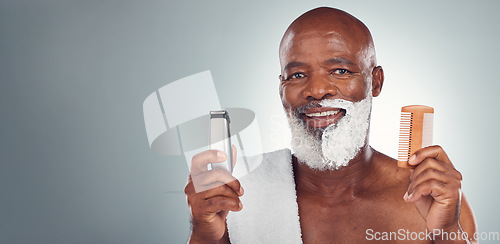 Image of Black man, beard and shaving with razor, cream or comb in cosmetics for skincare, grooming or self care against gray studio background. Portrait of happy African American male and shave kit on mockup