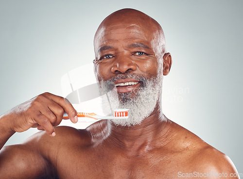 Image of Dental care portrait, senior man and morning toothbrush for oral hygiene in studio for wellness. Gray background, happy face and elderly person with teeth cleaning product and toothpaste product