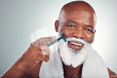 Image of Black man, face and cream to shave with razor, portrait for beauty and grooming isolated on studio background. Facial hair removal, happy elderly person and hygiene with skincare and wellness