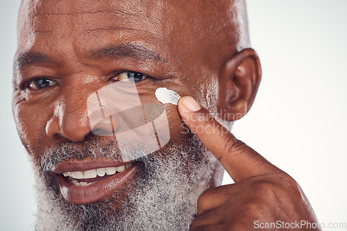 Image of Face cream, skincare and senior man in studio for wellness, beauty and grooming against grey background. Facial, skin and elderly model relax with luxury, cosmetics and wrinkle product while isolated