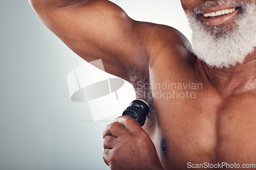 Image of Studio, black man and armpit with deodorant, smile and body care and grooming space isolated on grey background. Skincare, health and happy senior male with skin product for cleaning and wellness.