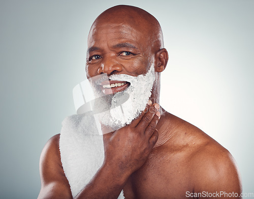 Image of Black man, face and shaving cream, smile in portrait for beauty and grooming isolated on studio background. Facial hair removal, happy elderly person and hygiene with skincare, glow and wellness