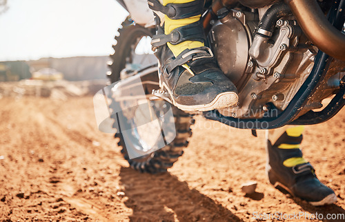 Image of Dirt road, competition and man feet on motorcycle in desert for exercise, training or rally. Offroad, fitness and male athlete or biker riding on motorbike for action, adventure and extreme sports.