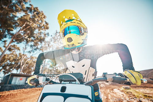 Image of Motorcross, motorcycle and man in helmet for sports challenge, offroad race and desert sunshine. Driver, bike and gear for dirt track competition, motorbike performance and action on adventure course