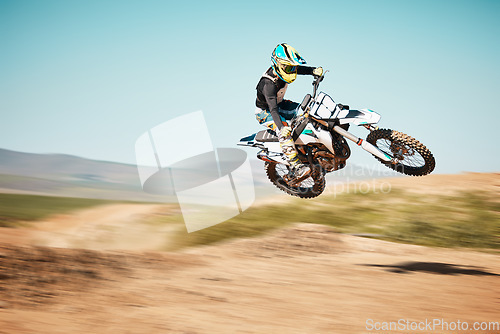 Image of Motorcross, air jump and offroad sports with motion blur, speed challenge or desert. Driver, cycling and stunt on dirt track, competition and motorbike performance on adventure course for fast action